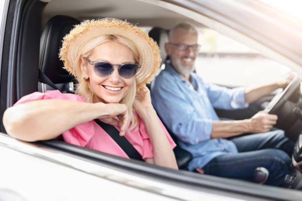 istock Joyful senior lady posing from car window 2154037642