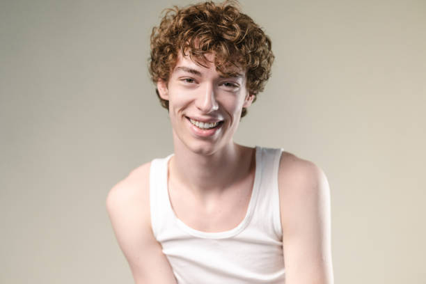 Studio shot of  generation Z man in white undershirt looking at the camera
