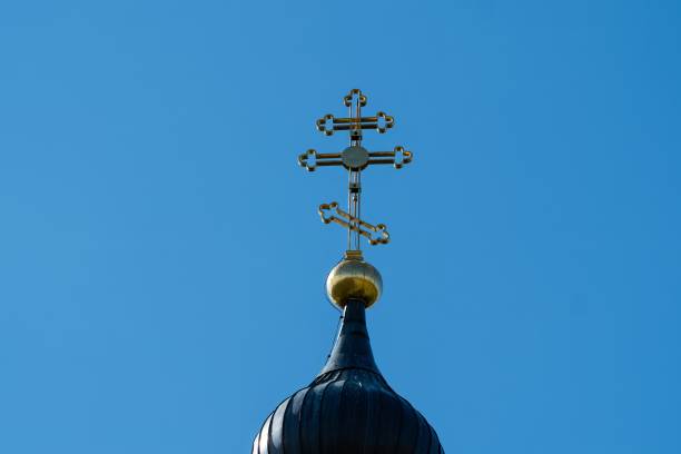istock Ornate Church Cross Against Clear Blue Sky 2154039916