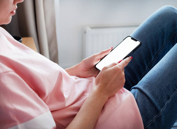 istock Woman using smartphone with blank screen at home 2154042766