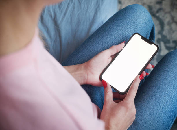 istock Woman using smartphone with blank screen at home 2154042767