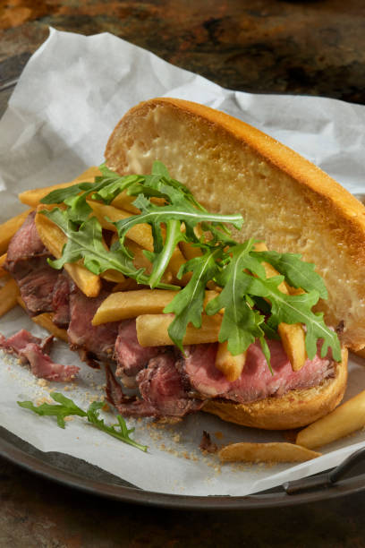 Steak Frites - Medium Rare Strip Loin Steak Sandwich with French Fries, Arugula and Garlic Aioli