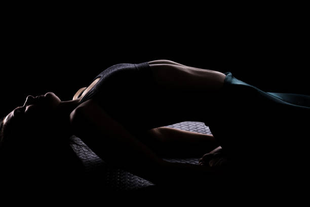 A captivating close-up portrait of a young woman, showcasing her silhouette in a sports outfit, emphasizing strength and elegance.