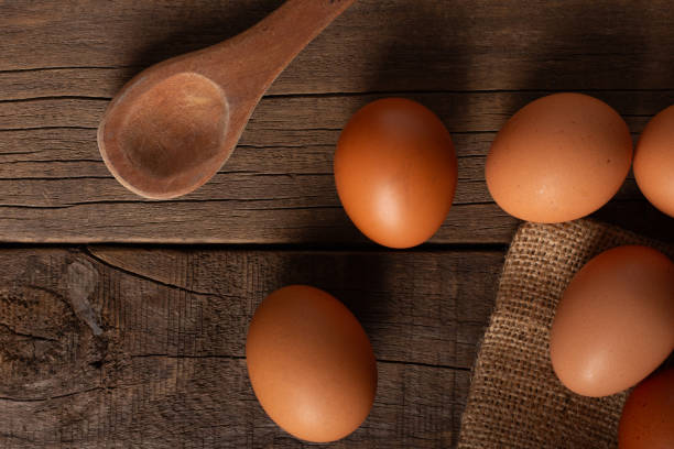 istock Brown eggs with wooden spoon on a wooden table 2154047164