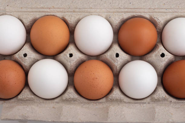 istock Top view of fresh chicken eggs in paper box package 2154047280