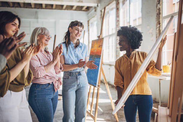 istock Art class in progress: teacher and students engage in canvas painting 2154047462