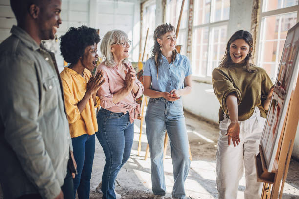 istock Art class enthusiasm: teacher and students engaging in canvas painting 2154047500
