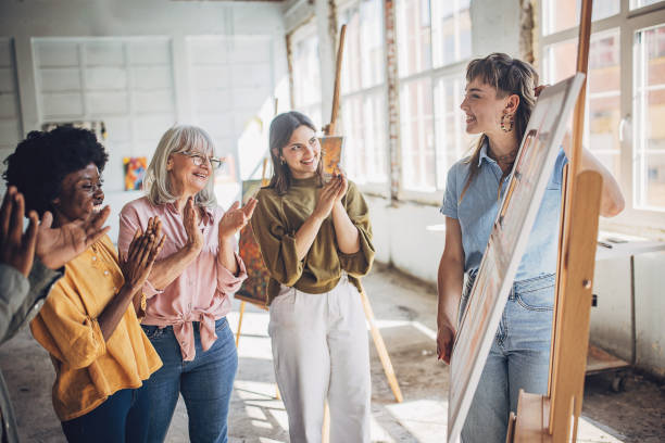 istock Art class enthusiasm: teacher and students engaged in canvas painting 2154047912