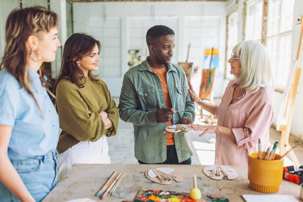 istock Art class in session: teacher guiding students in painting workshop 2154048906