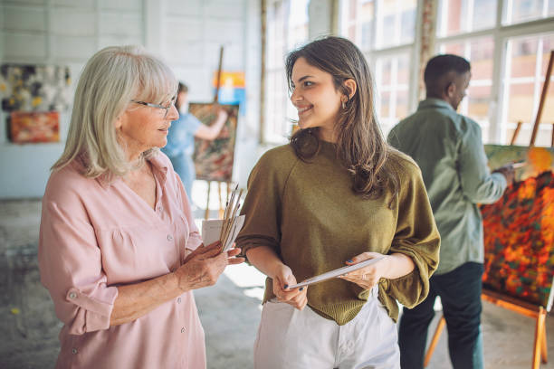 Art class engagement: teacher guiding student in painting techniques