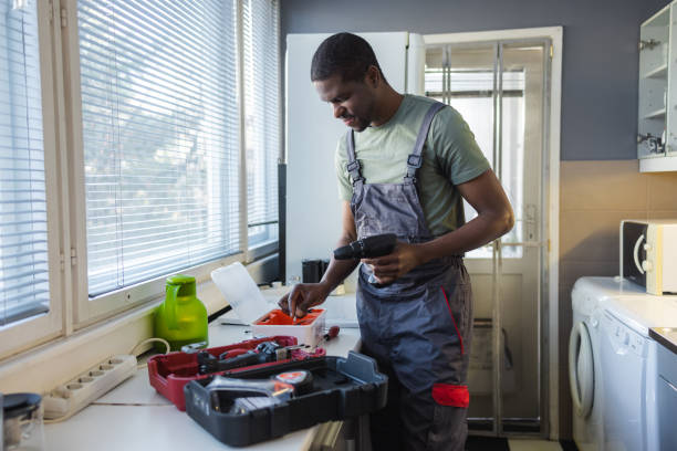 Handyman preparing tools for work at customer's home Photo of African American handyman working in the customer's kitchen african american plumber stock pictures, royalty-free photos & images