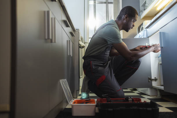 istock The plumber fixing the sink in the kitchen 2154051908