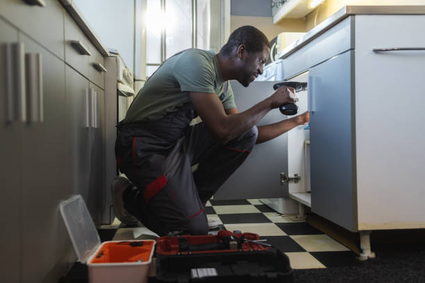 istock The plumber fixing the sink in the kitchen 2154051937