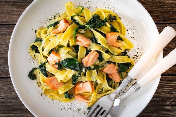 istock Pappardelle with grilled salmon and spinach on wooden table 2154052298