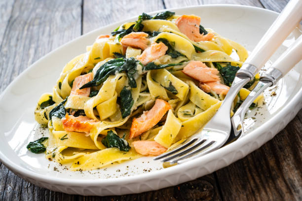 istock Pappardelle with grilled salmon and spinach on wooden table 2154052305