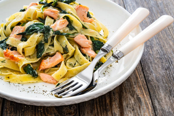 istock Pappardelle with grilled salmon and spinach on wooden table 2154052312