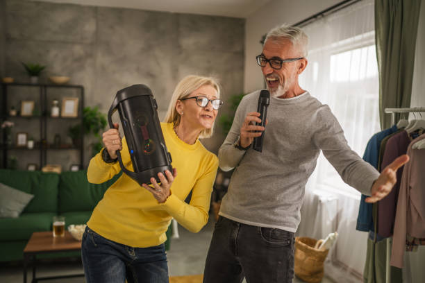 istock Mature man hold microphone and sign while mature wife hold loudspeaker 2154052641