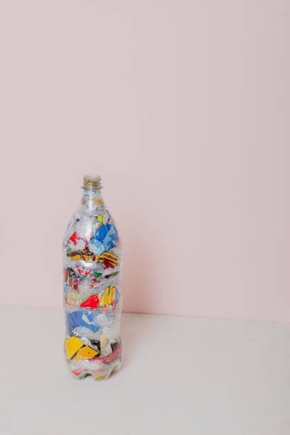 istock isolated eco brick PET bottle stuffed with plastic waste 2154052674