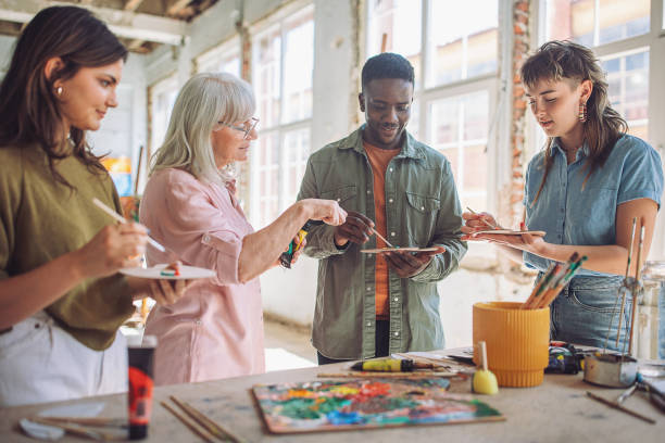 istock Art class in session: teacher and students engaging in canvas painting 2154052738