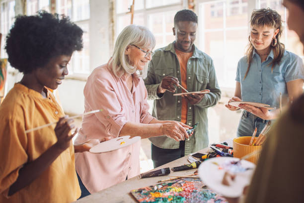 istock Art class in progress: teacher guiding aspiring painters 2154053136
