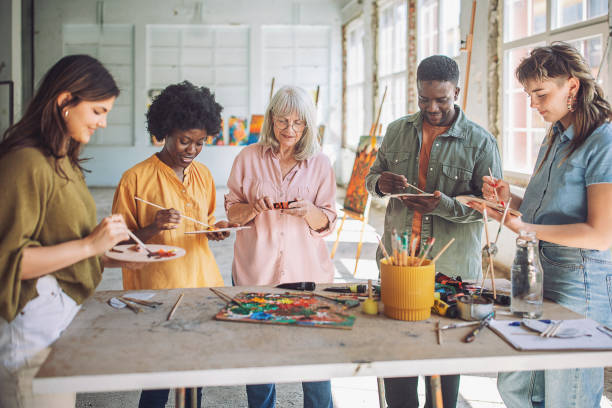 istock Art class in session: teacher guiding students in painting techniques 2154053167