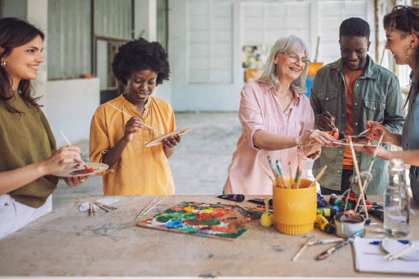istock Joyful art class: teacher and students engage in canvas painting 2154053743