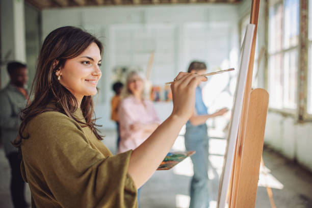 istock Art class in action: teacher and students engaged in painting 2154053846