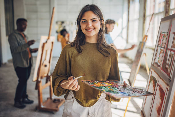 istock Art school creativity: teacher and students engaged in canvas painting 2154053972