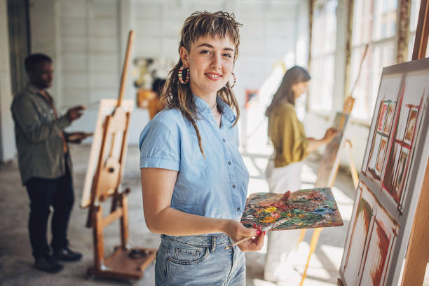 istock Creative art class session: teacher and students engaged in canvas painting 2154053999