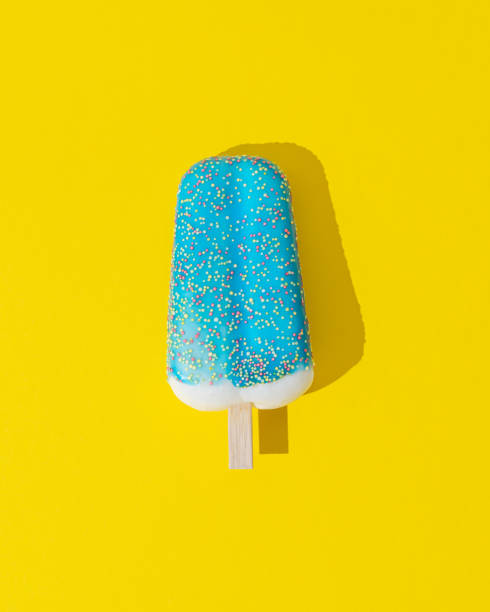 istock Blue glazed ice cream popsicle on yellow background. Minimal summer concept. Ice cream aesthetic. Flat lay. 2154054257