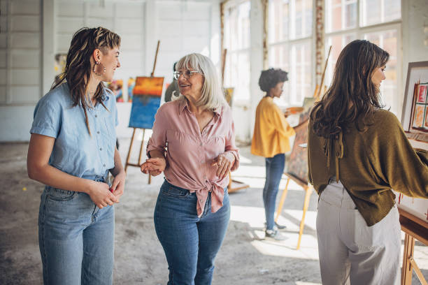 istock Creative workshop: art teacher guiding students in painting class 2154054490