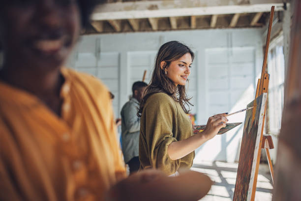 istock Art school creativity: teacher and students engaged in canvas painting 2154054621