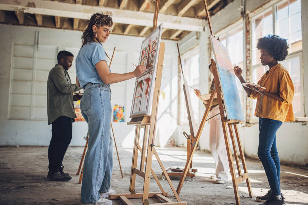 istock Art class in session: teacher guiding students in painting 2154054953