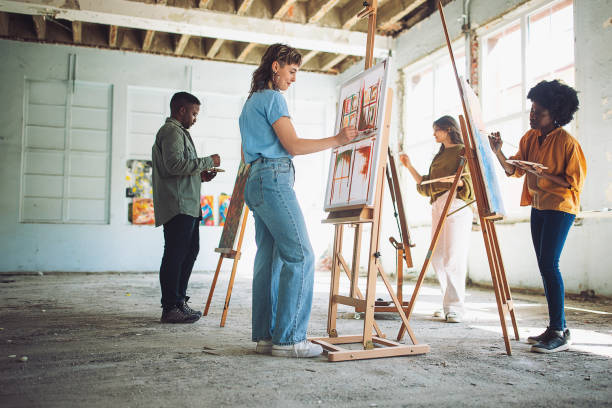 istock Creative art class in session: teacher and students engage in canvas painting 2154055161