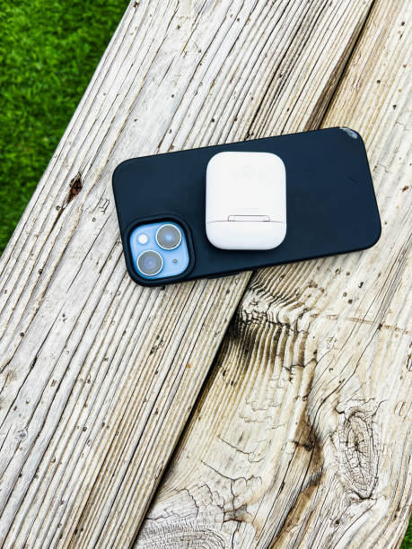 istock Smart Phone and Ear Pods Case on a Wooden Bench 2154055877