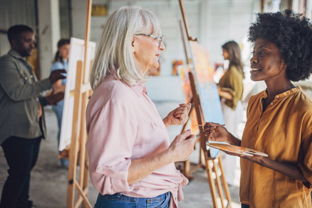 istock Art teacher guiding student in painting class 2154055887