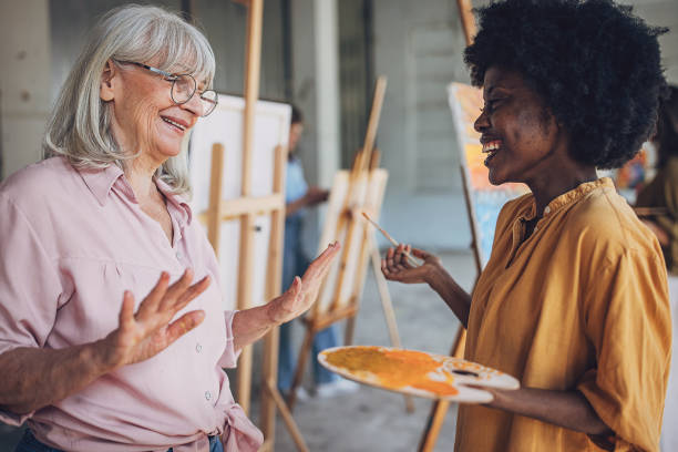 istock Art class engagement: teacher guiding student in painting techniques 2154055970