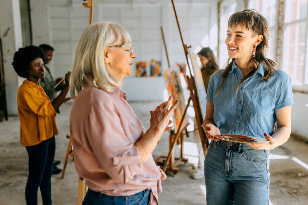 istock Art class in progress: teacher and students engaged in canvas painting 2154056029