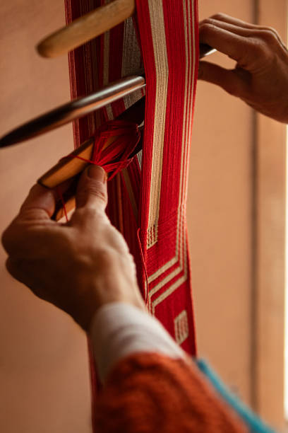 istock Closeup of a woman's hands working in her loom workshop 2154056258