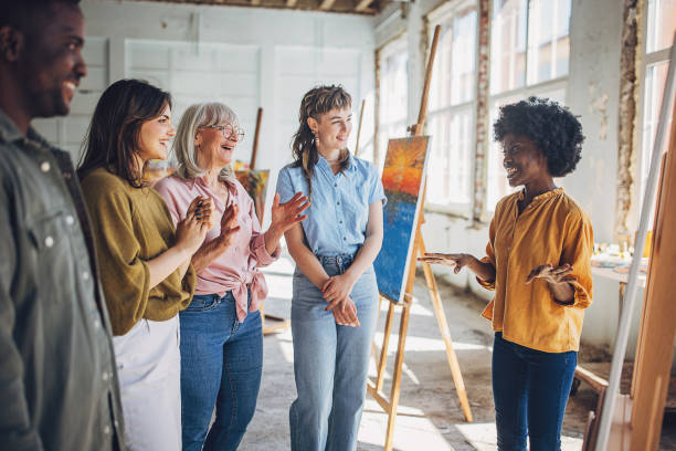istock Art class enthusiasm: teacher and students engage in canvas painting 2154056418