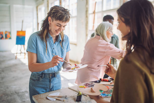 istock Art education: teacher and students engage in canvas painting 2154056543