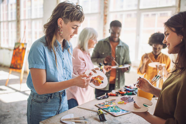istock Art class in session: teacher guiding students in painting workshop 2154056562