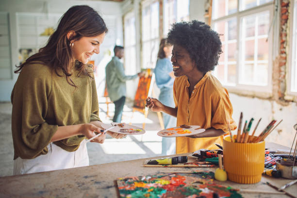 istock Art class creativity: teacher and students engaged in painting 2154056839