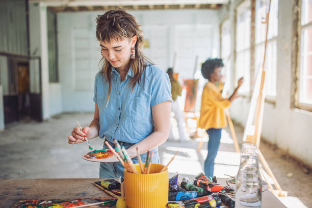 Creative process in art class: teacher and students painting