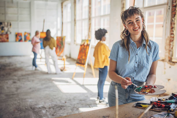 istock Creative art class - teacher guiding students in painting workshop 2154057126