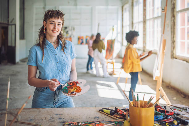 istock Art class inspiration: teacher and students engaged in canvas painting 2154057137