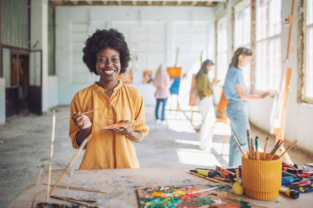 istock Art class creativity: teacher and students engaged in painting 2154057159