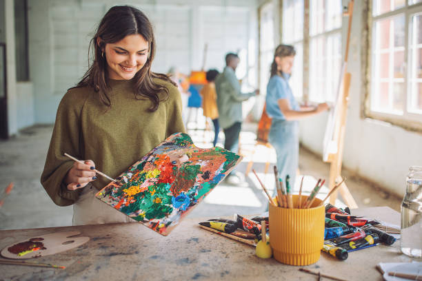 istock Art class in session: teacher and students engaged in canvas painting 2154057328