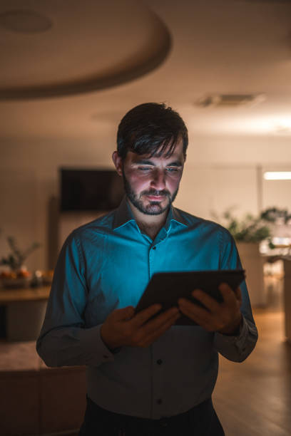 istock Professional Working Late on Tablet at Home 2154057395