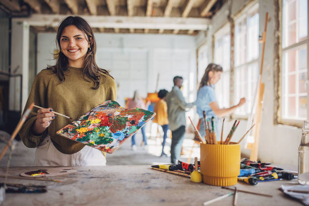istock Art class in session: teacher and students engaged in canvas painting 2154057511